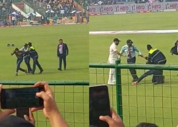 Mohammed Shami comes to protect a pitch invader after security personnel slaps him